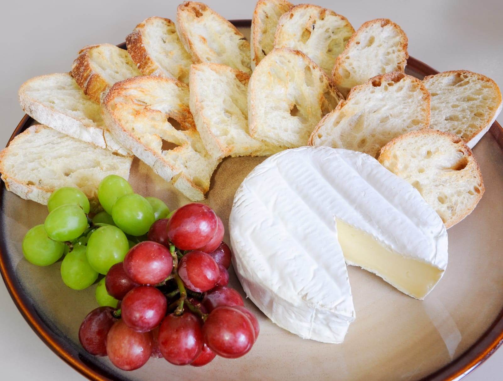 Brie served with Crostini and Grapes