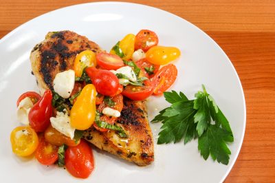 Garlic Basil Chicken topped with Caprese Salad