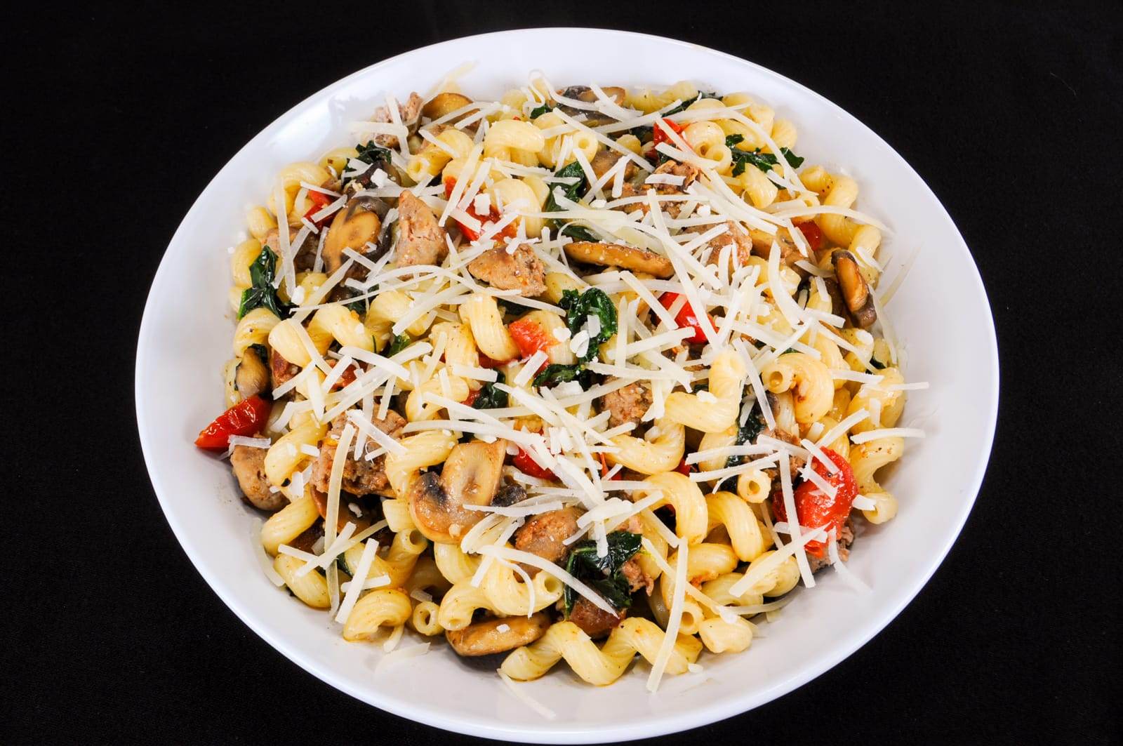 Cavatappi Pasta with Turkey Italian Sausage, Mushrooms, Tomatoes, and Kale