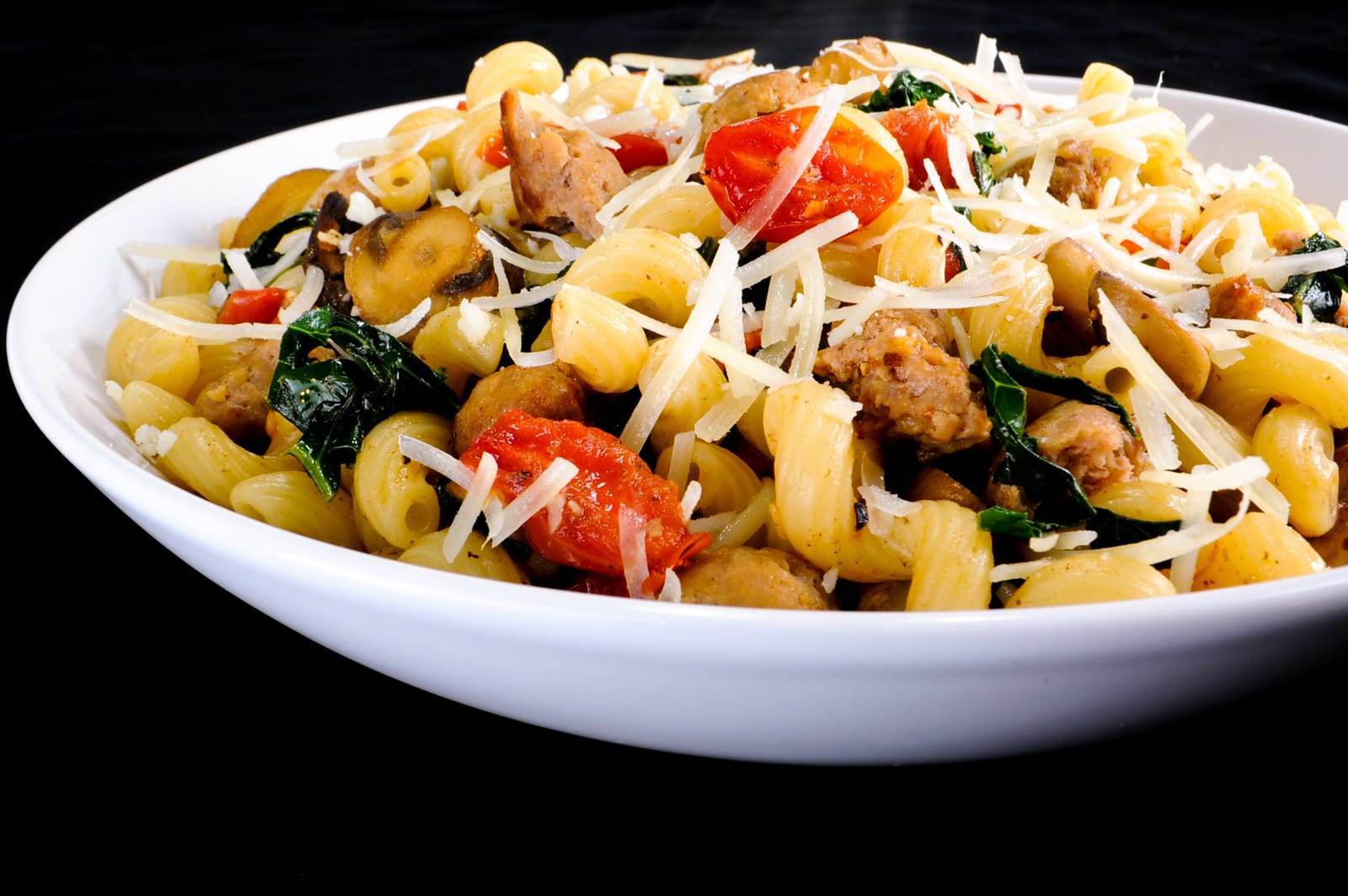 Cavatappi Pasta with Turkey Italian Sausage, Mushrooms, Tomatoes, and Kale