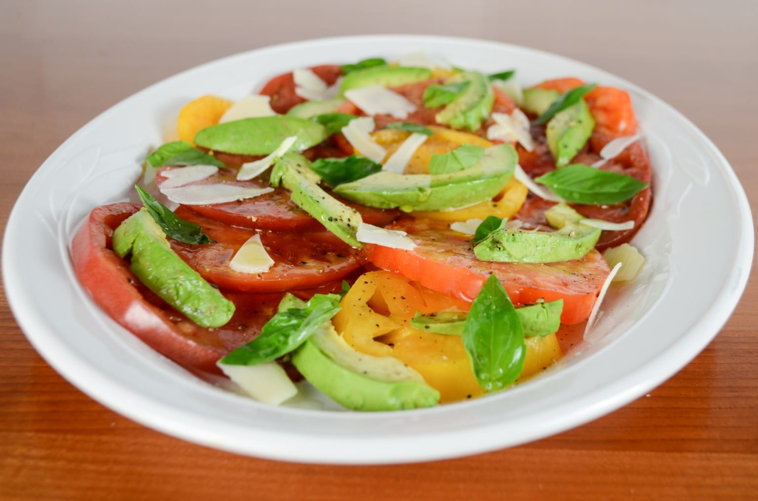 Sliced Heirloom Tomato And Avocado Salad With Basil And Shaved Parmesan ...