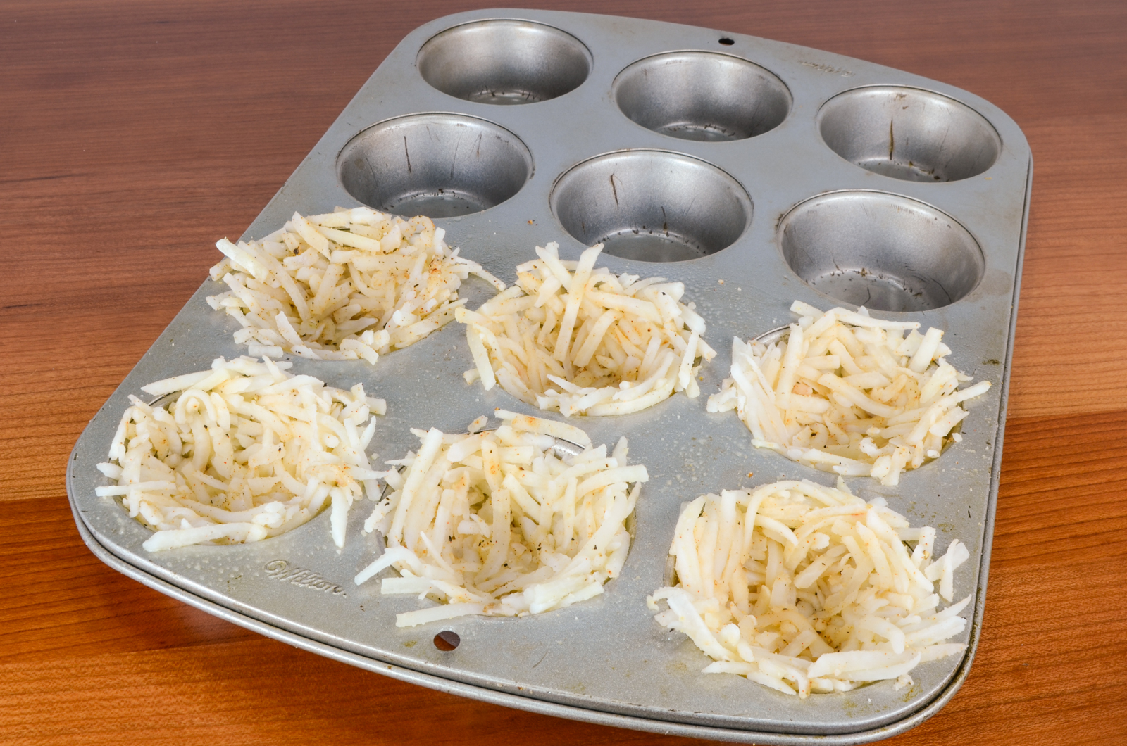 Hash Brown Nests with Egg, Ham, and Sharp Cheddar