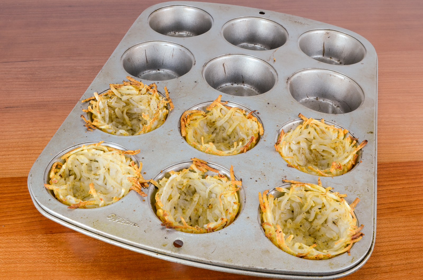 Hash Brown Nests with Egg, Ham, and Sharp Cheddar