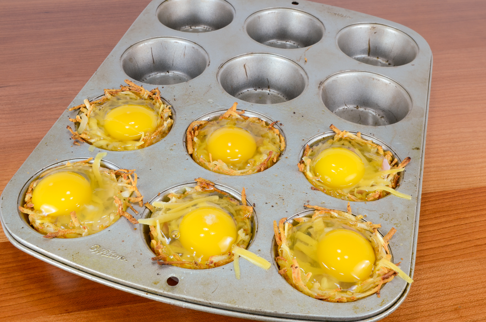 Hash Brown Nests with Egg, Ham, and Sharp Cheddar