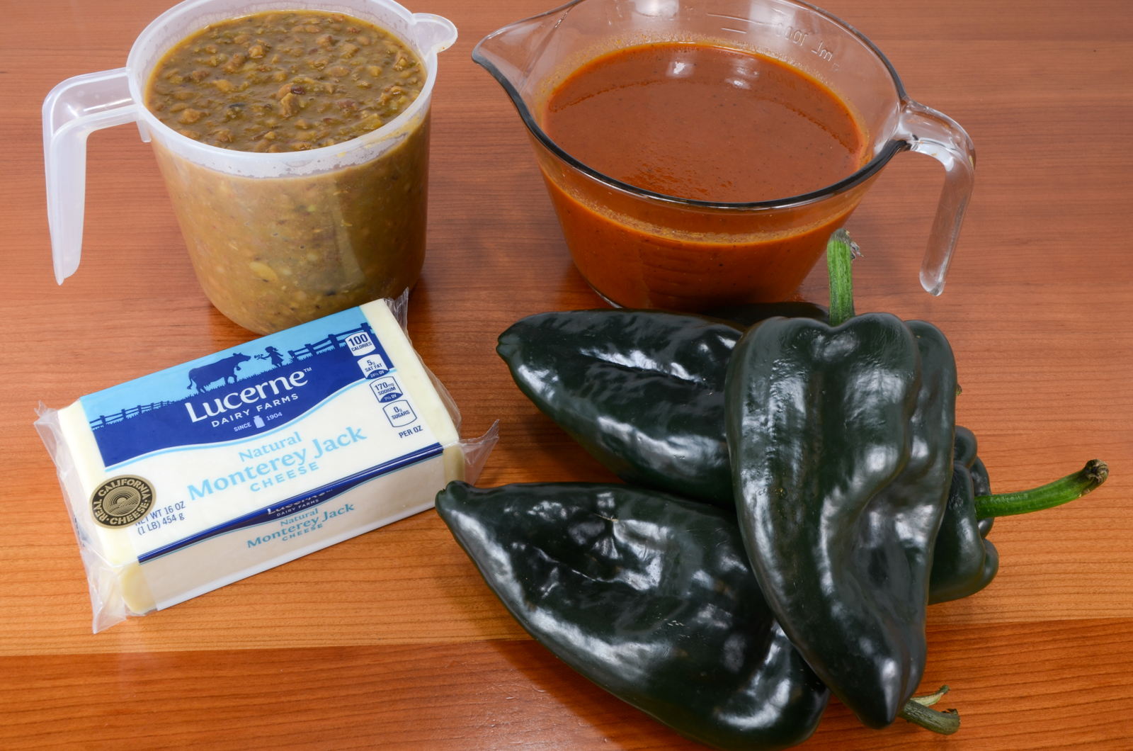 Cheesy Roasted Poblano Peppers with Homemade Refried Beans and Enchilada Sauce