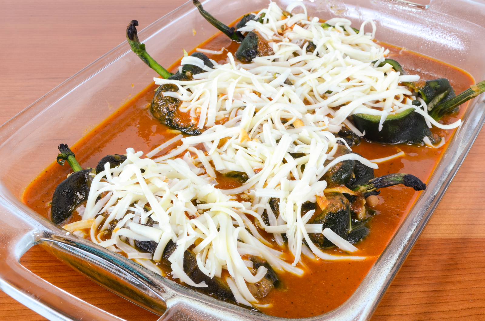 Cheesy Roasted Poblano Peppers with Homemade Refried Beans and Enchilada Sauce