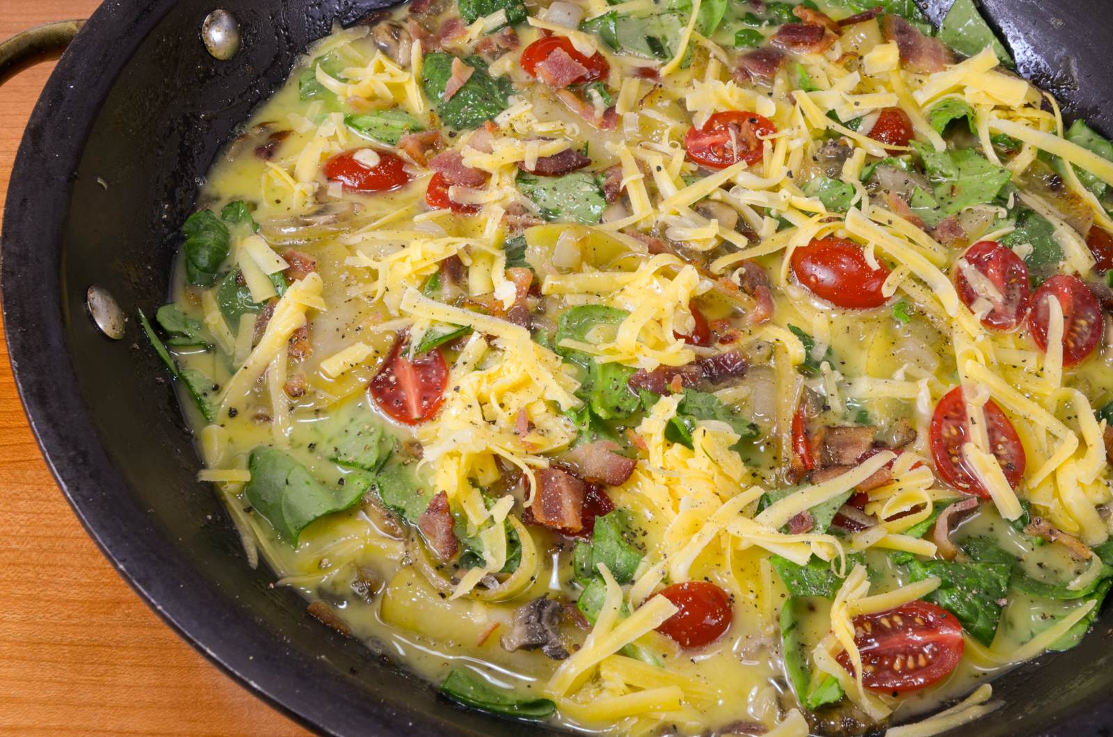 Baked Spanish Tortilla with Potato, Bacon, Onion, Mushroom, Tomato, Spinach, and Sharp Cheddar