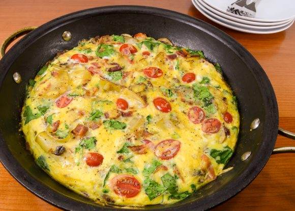 Baked Spanish Tortilla with Potato, Bacon, Onion, Mushroom, Tomato, Spinach, and Sharp Cheddar