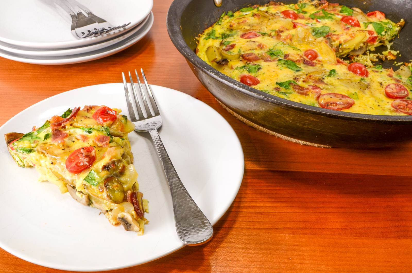 Baked Spanish Tortilla with Potato, Bacon, Onion, Mushroom, Tomato, Spinach, and Sharp Cheddar