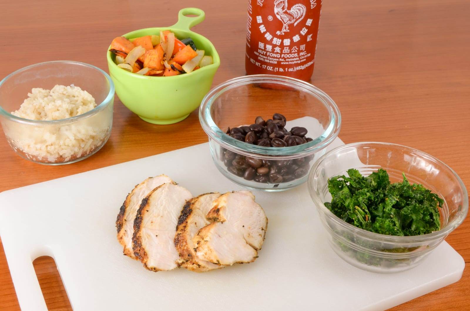 Rice Bowl with Spicy Chicken, Roasted Sweet Potatoes & Vegetables, Black Beans, and Kale