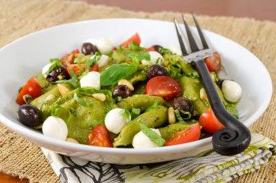 Spinach and Kale Ravioli Pasta Salad with Fresh Tomatoes, Basil, Mozzarella, and Taggiasca Olives