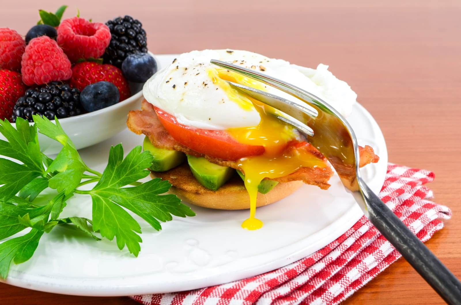 Poached Egg with Bacon, Tomato, and Avocado on a Bagel