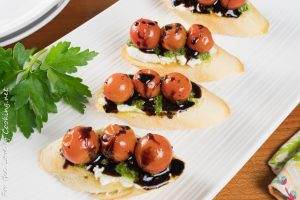 Crostini with Goat Cheese, Pesto, Roasted Tomatoes, and a Balsamic Drizzle