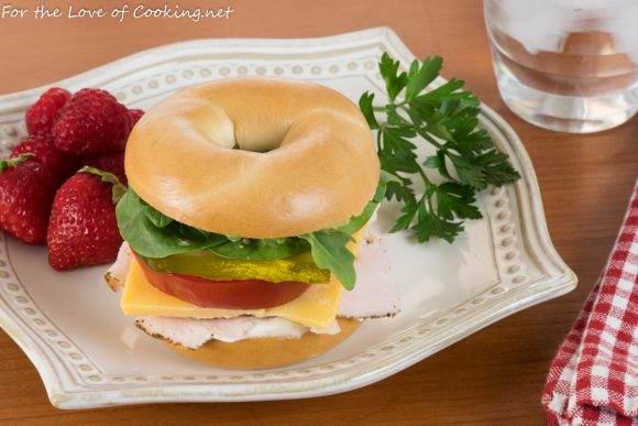 Turkey and Sharp Cheddar Bagel Sandwich with Arugula, Spinach, and Tomatoes