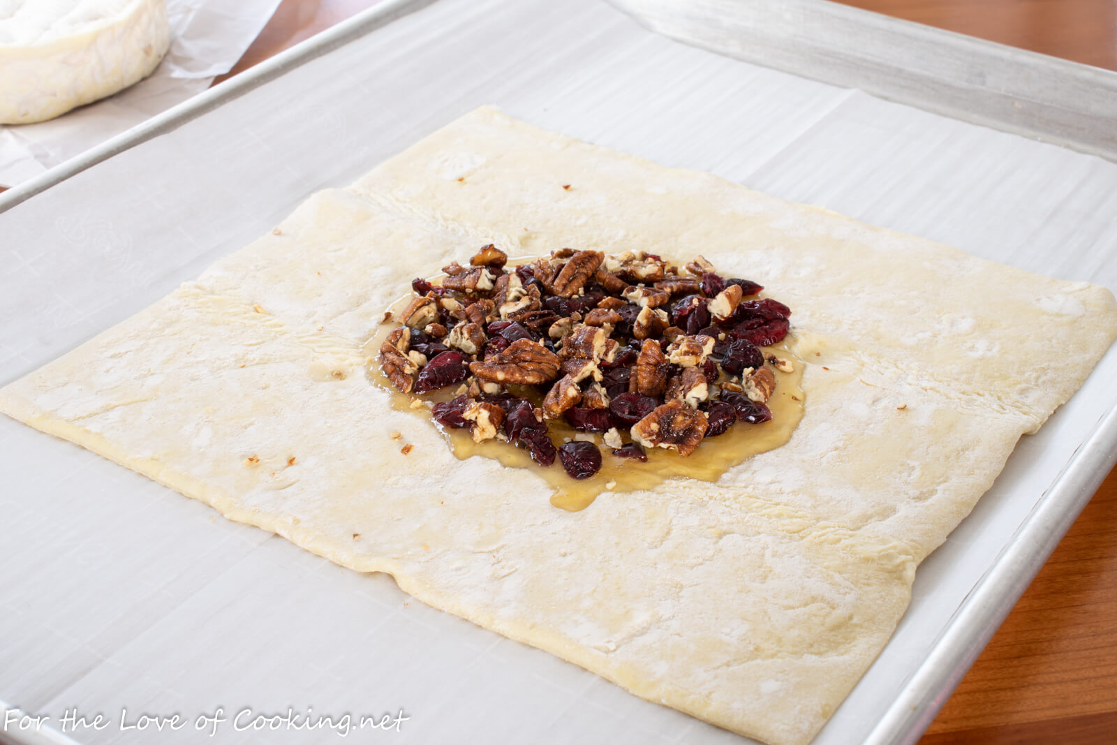 Baked Brie en Croute (with Honey, Candied Pecans and Cranberries)