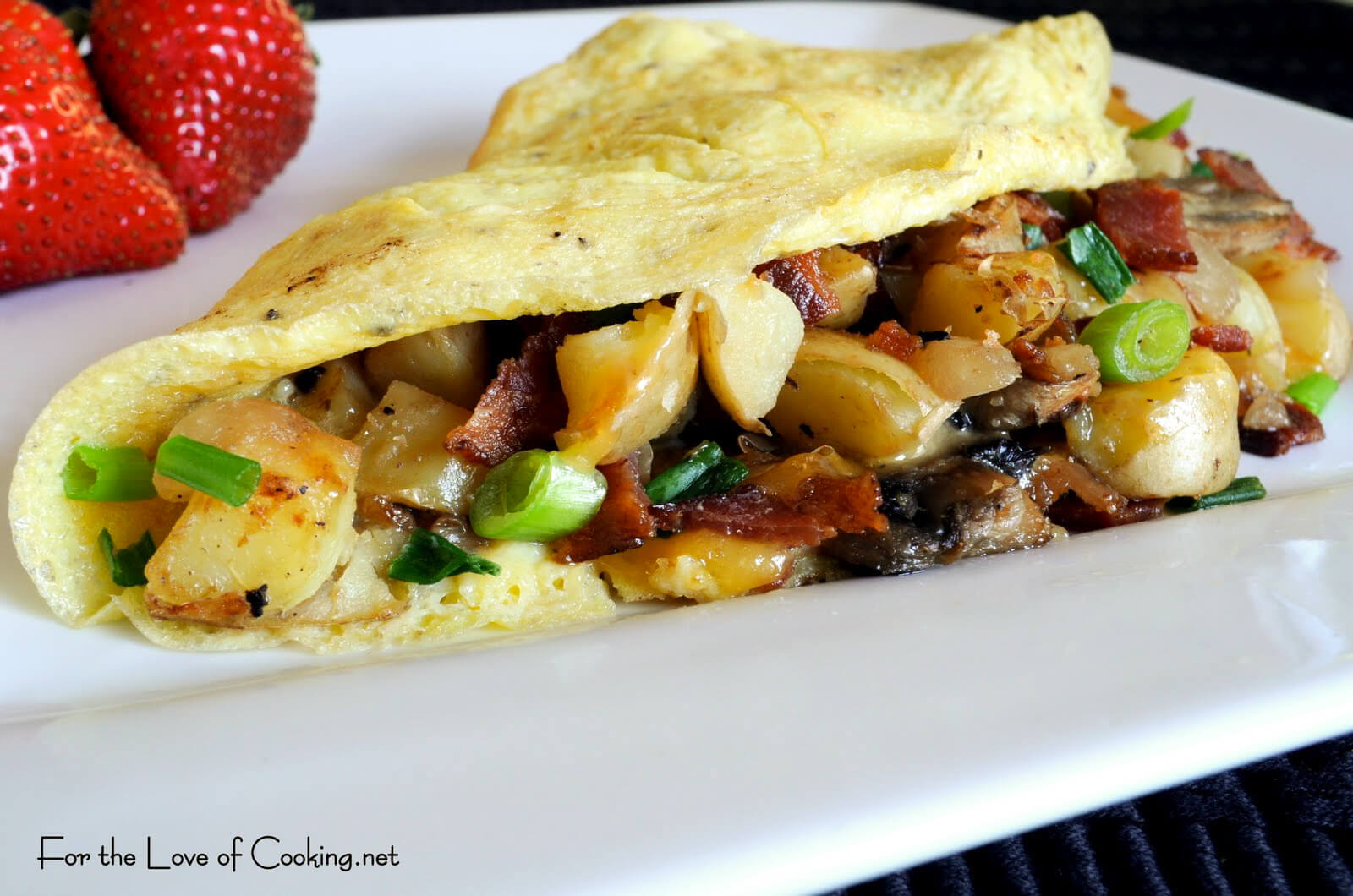 Peasant Omelet with Potatoes, Mushrooms, Bacon, and Cheddar